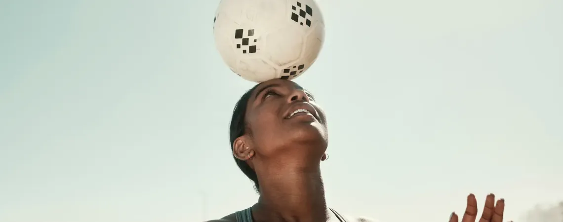 a person with a bandage on their head holding a soccer ball
