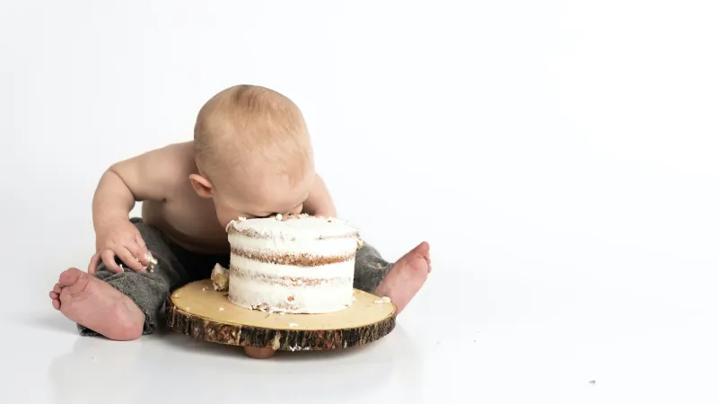 baby eating cake