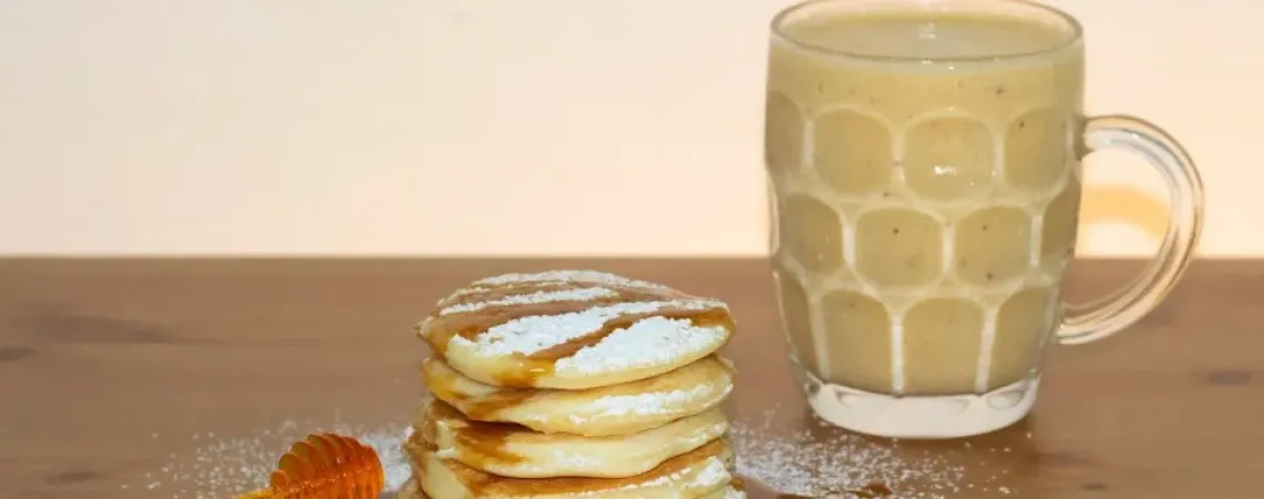 Pancakes with maple syrup and a latte