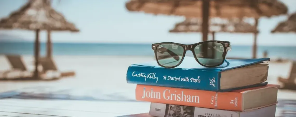 Pile of books with a view on the ocean