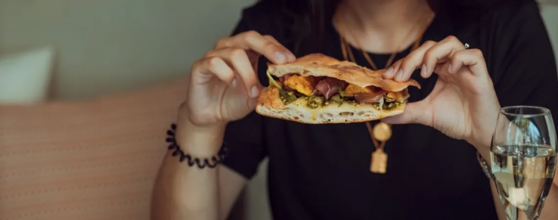 Woman eating mindfully her sandwich at a restaurant