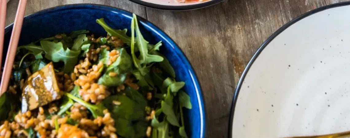 Arugula salad with prosciutto on a table