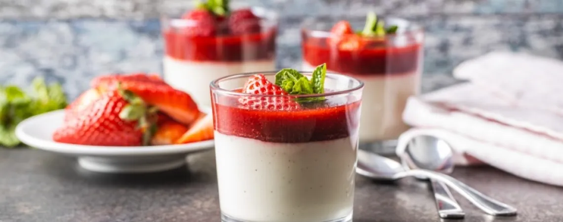 Delicate dessert topped with fresh strawberry sauce and berries, ready to be enjoyed, highlighting a healthy and elegant treat.