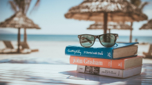 Pile of books with a view on the ocean 