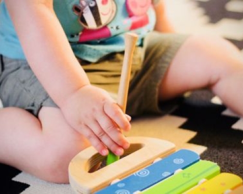 Obese child playing xylophone