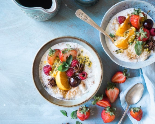 two bowls of oatmeal with fruits