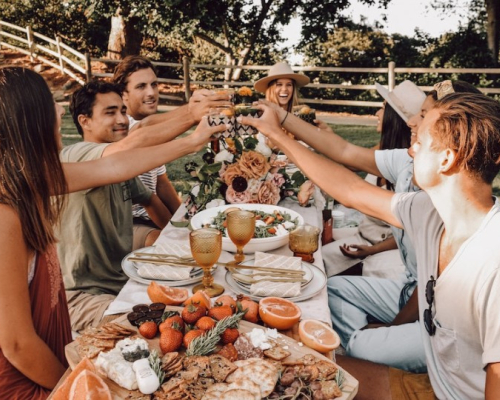 festive young adults celebrating by eating out