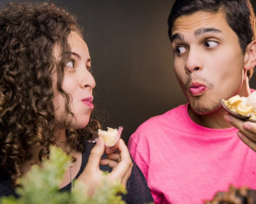 man and woman eating while looking at each other