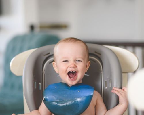 smiling baby in highchair