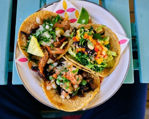 3 shrimp tacos served on a plate