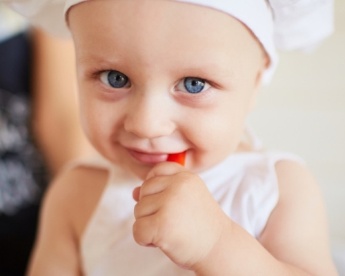 blue-eyed child in a chef's hat