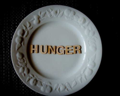 plate with fruits symbols with ''HUNGER'' inscription