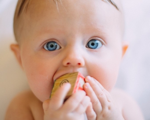 Blue-eyed baby who is teething