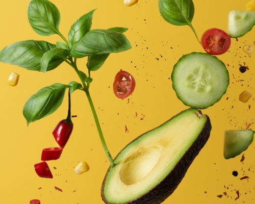 avocado, cucumber, tomatoes, basilic on a yellow background