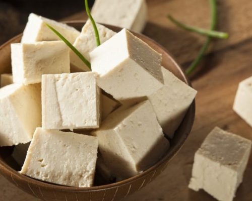 Small tofu cubes in a small wooden bowl