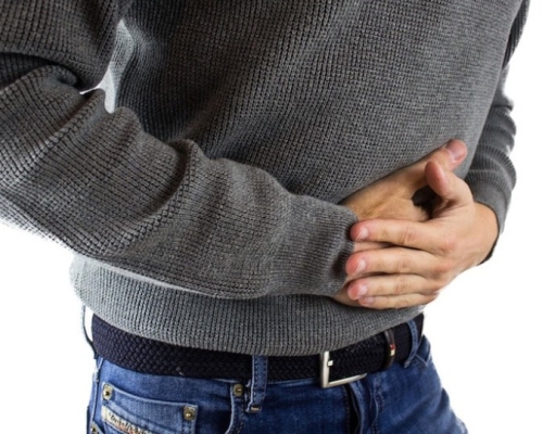 Man with a grey shirt having bloating