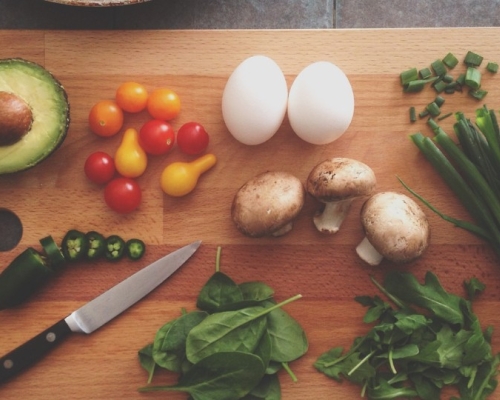 vegetables and proteins on a wooden cutting board