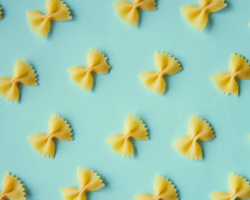 looped pasta on a pale blue background