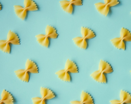 looped pasta on a pale blue background