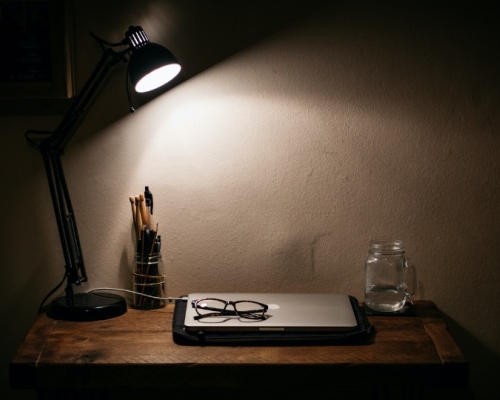 work desk illuminated by a lamp