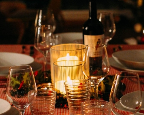 meal on the table with bottle of wine and candle