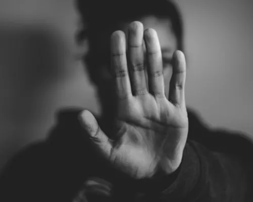 Woman who puts her hand in front of her face, no