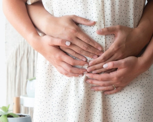 pregnant woman, nausea, hands on pregnant belly