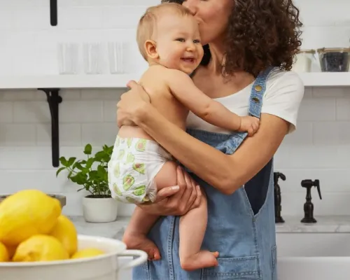 woman holding her baby in a kitchen