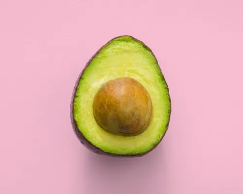 avocado in front of a pink background