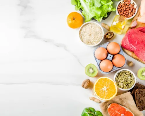 an assortment of healthy foods arranged on a marble surface