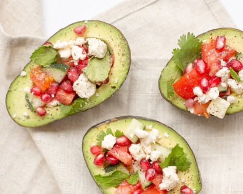 Three avocados stuffed with feta, tomatoes and mint 