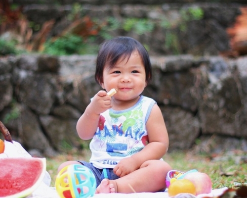 child eating at a picnic