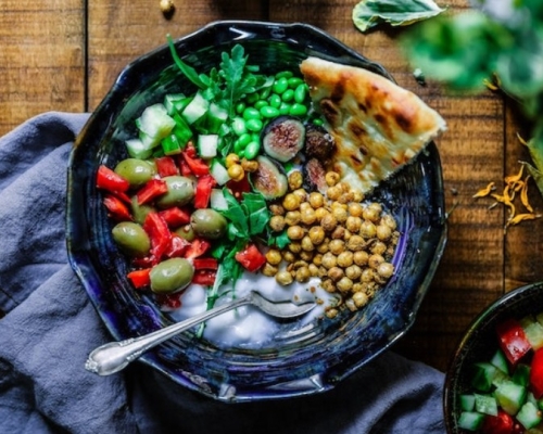 bol de légumes avec pois chiche concombre tomate et pain naan