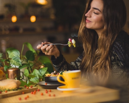 a woman eating vegetables