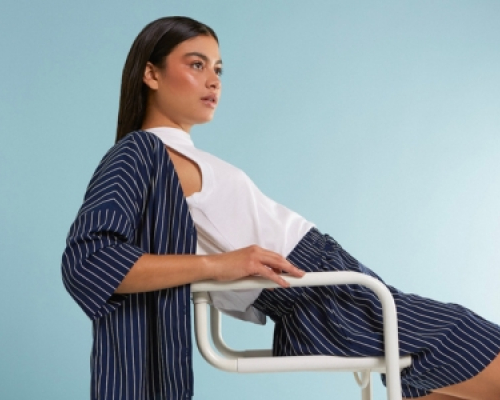 Woman sitting on a chair with FIG clothing