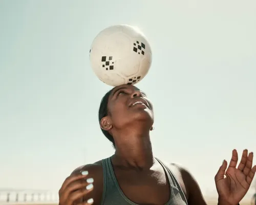 a person with a bandage on their head holding a soccer ball