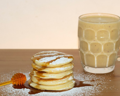 Pancakes with maple syrup and a latte