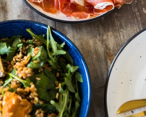 Arugula salad with prosciutto on a table