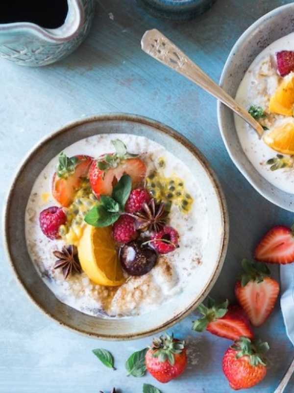 two bowls of oatmeal with fruits