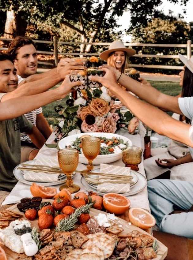 festive young adults celebrating by eating out