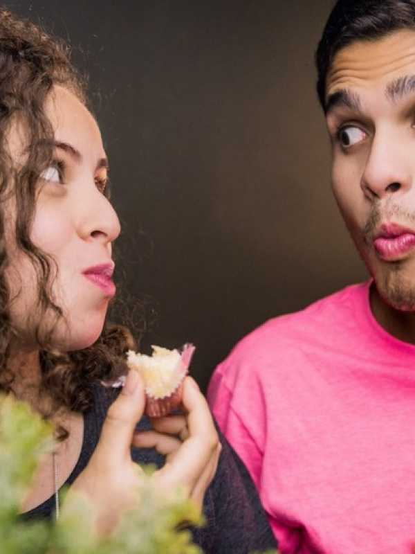 man and woman eating while looking at each other
