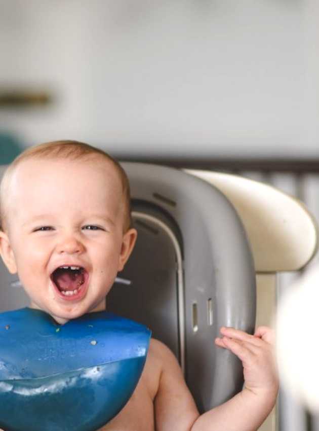 smiling baby in highchair