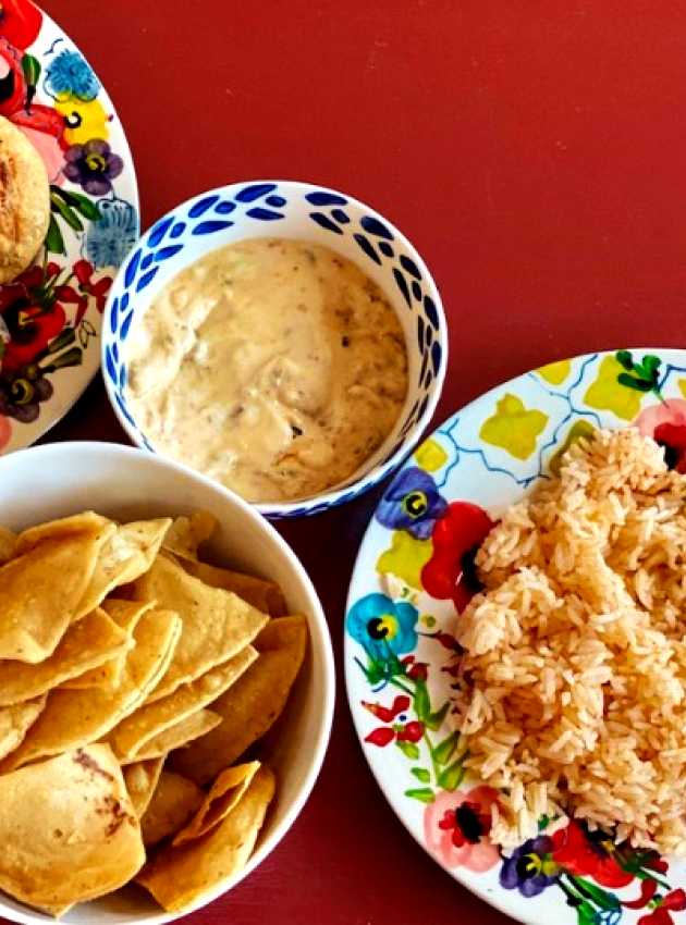 rice, patties and chips in dishes on a red background