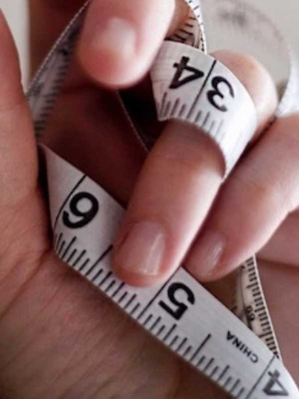hand holding a body measuring tape 