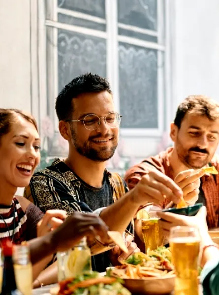 A group of friends enjoying a meal together at Nepan, Ottawa, sharing food and drinks in a casual, social setting.
