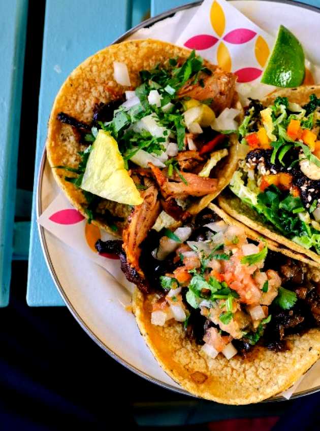 3 shrimp tacos served on a plate