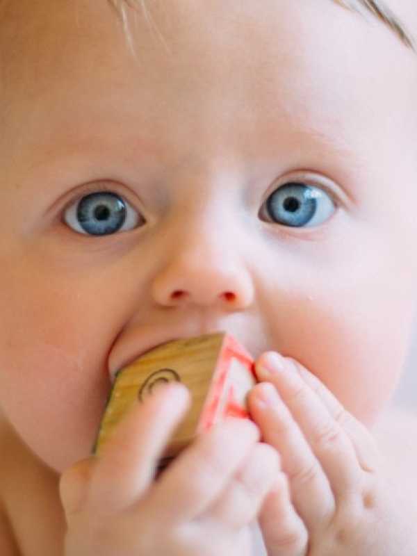 Blue-eyed baby who is teething