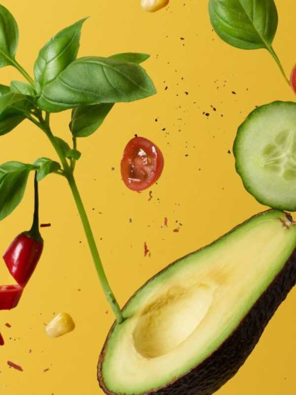 avocado, cucumber, tomatoes, basilic on a yellow background