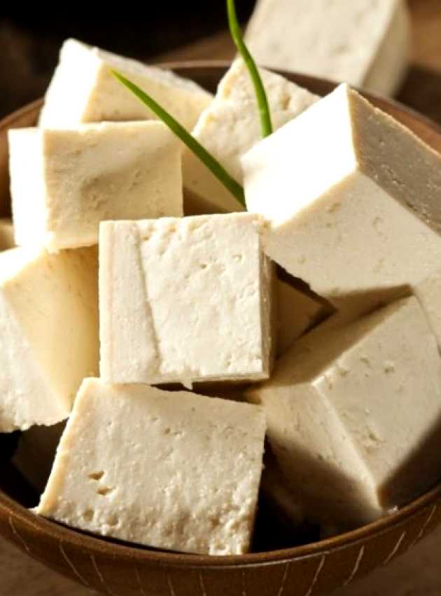 Small tofu cubes in a small wooden bowl