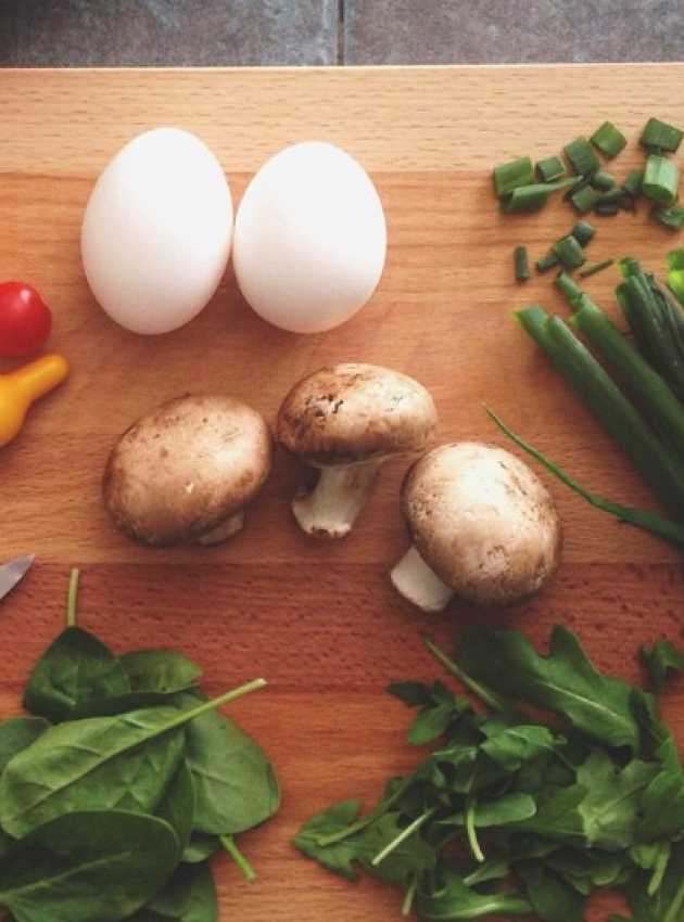 vegetables and proteins on a wooden cutting board